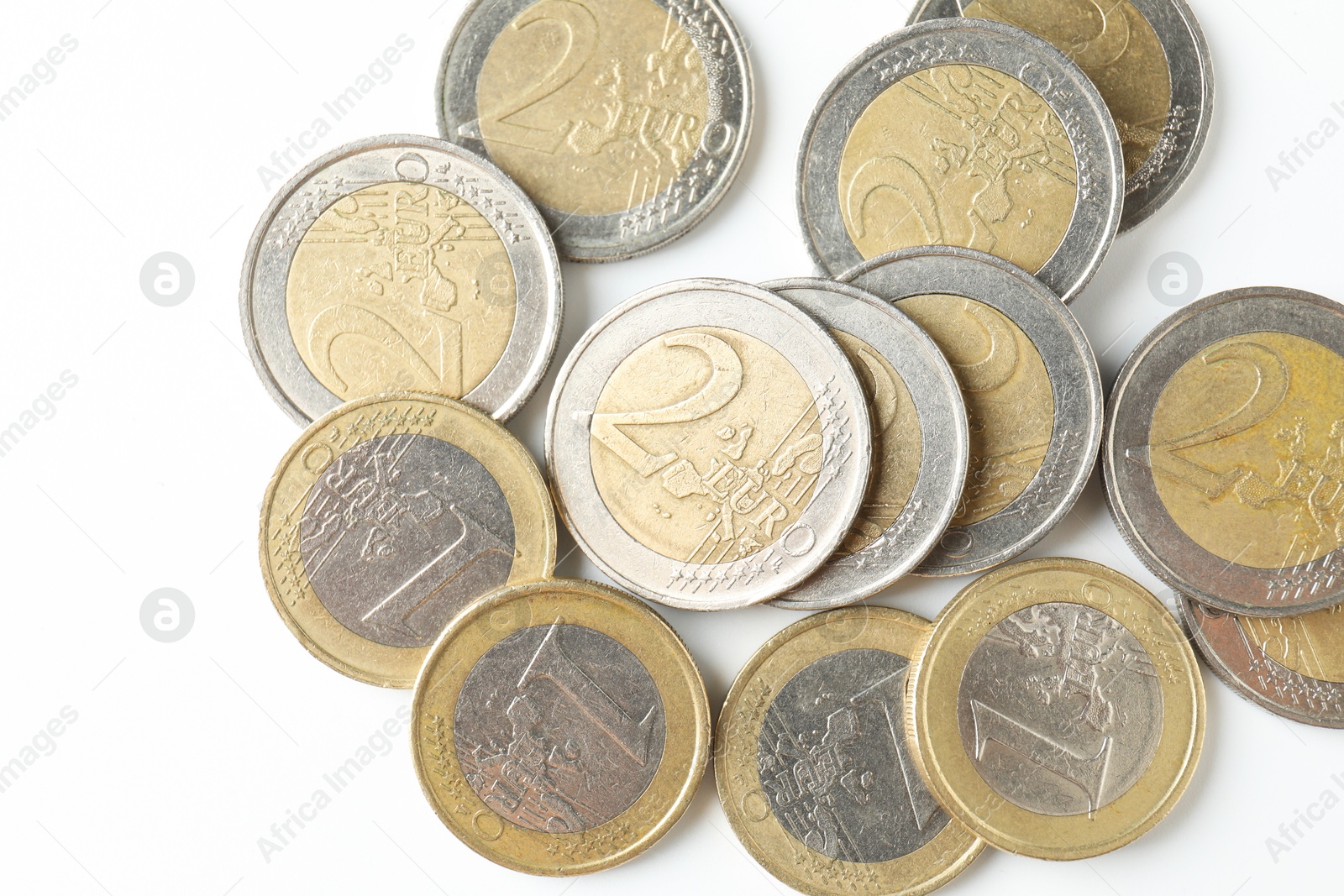 Photo of Many euro coins on white background, top view