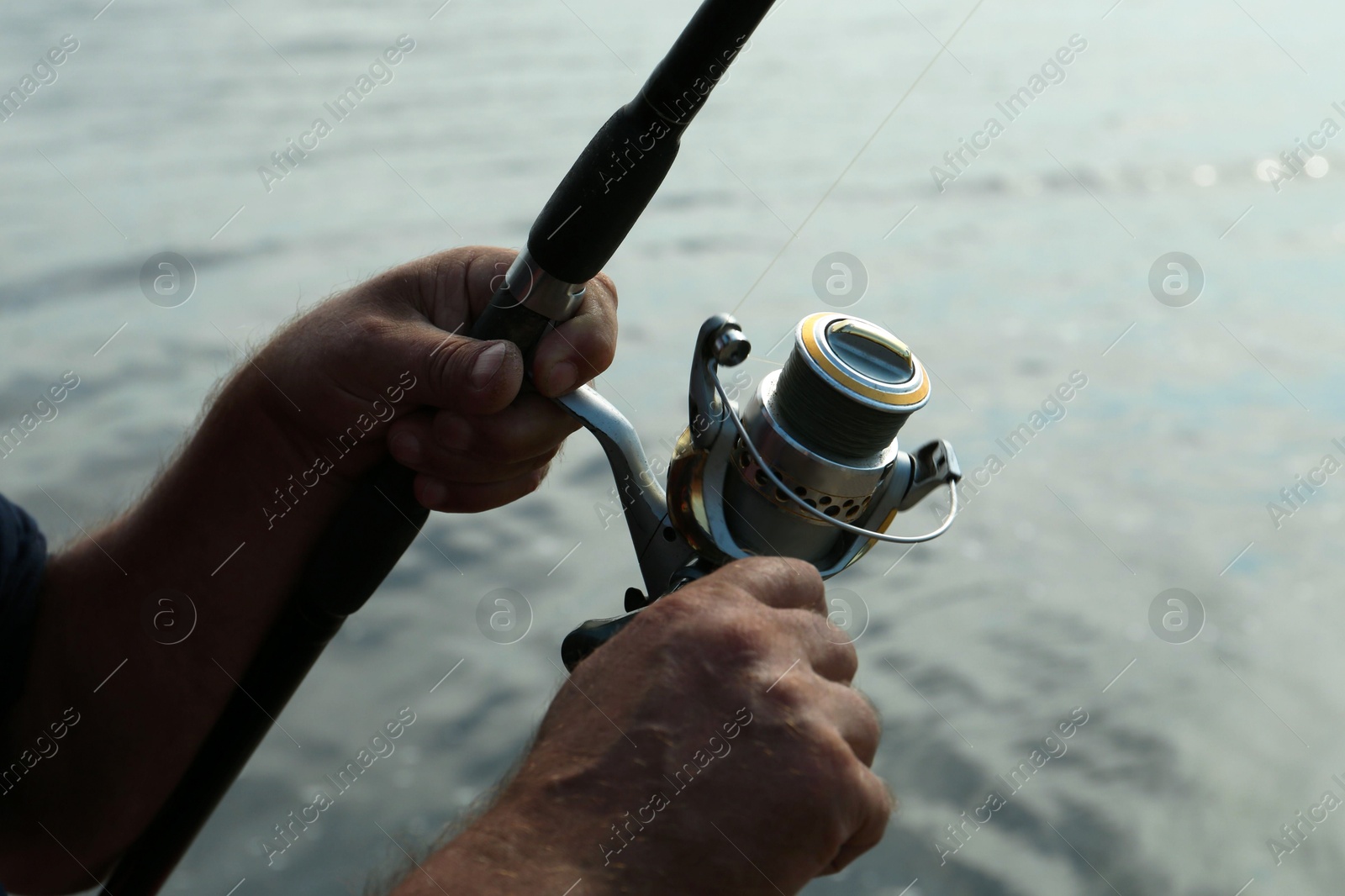 Photo of Fisherman with rod fishing near lake at summer, closeup