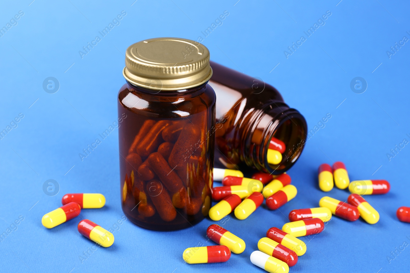 Photo of Pharmacist. Pills in plastic bottles on blue background