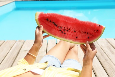 Photo of Woman with slice of juicy watermelon near swimming pool outdoors, closeup