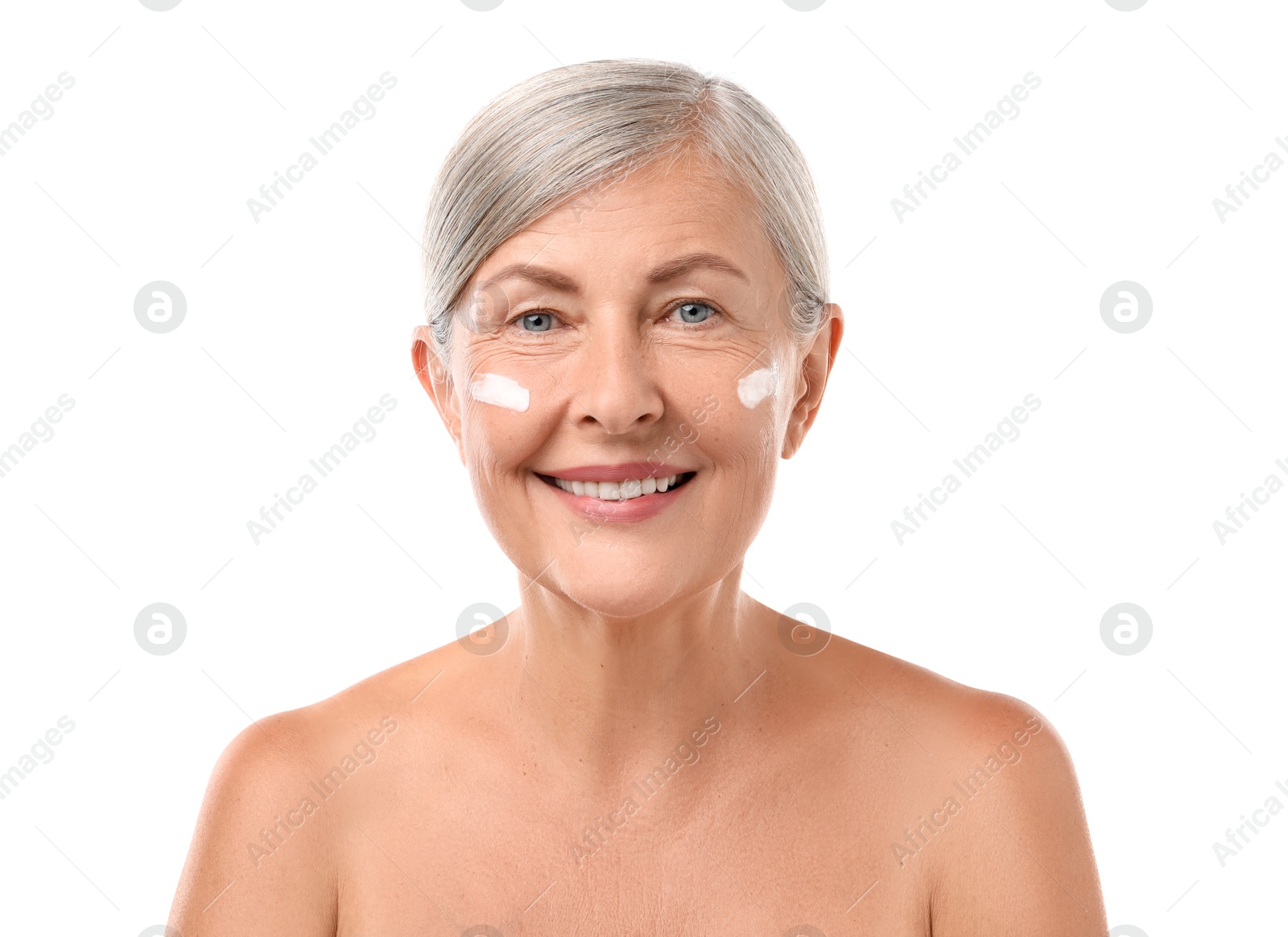 Photo of Senior woman with face cream on white background