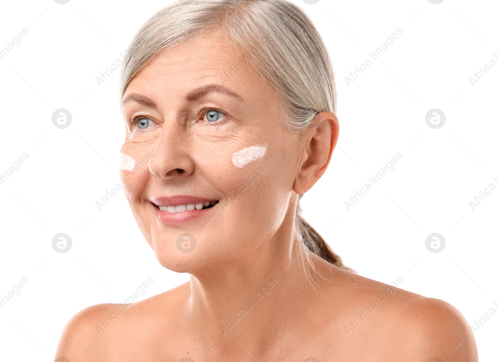 Photo of Senior woman with face cream on white background