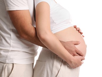 Photo of Man hugging her pregnant wife on white background, closeup