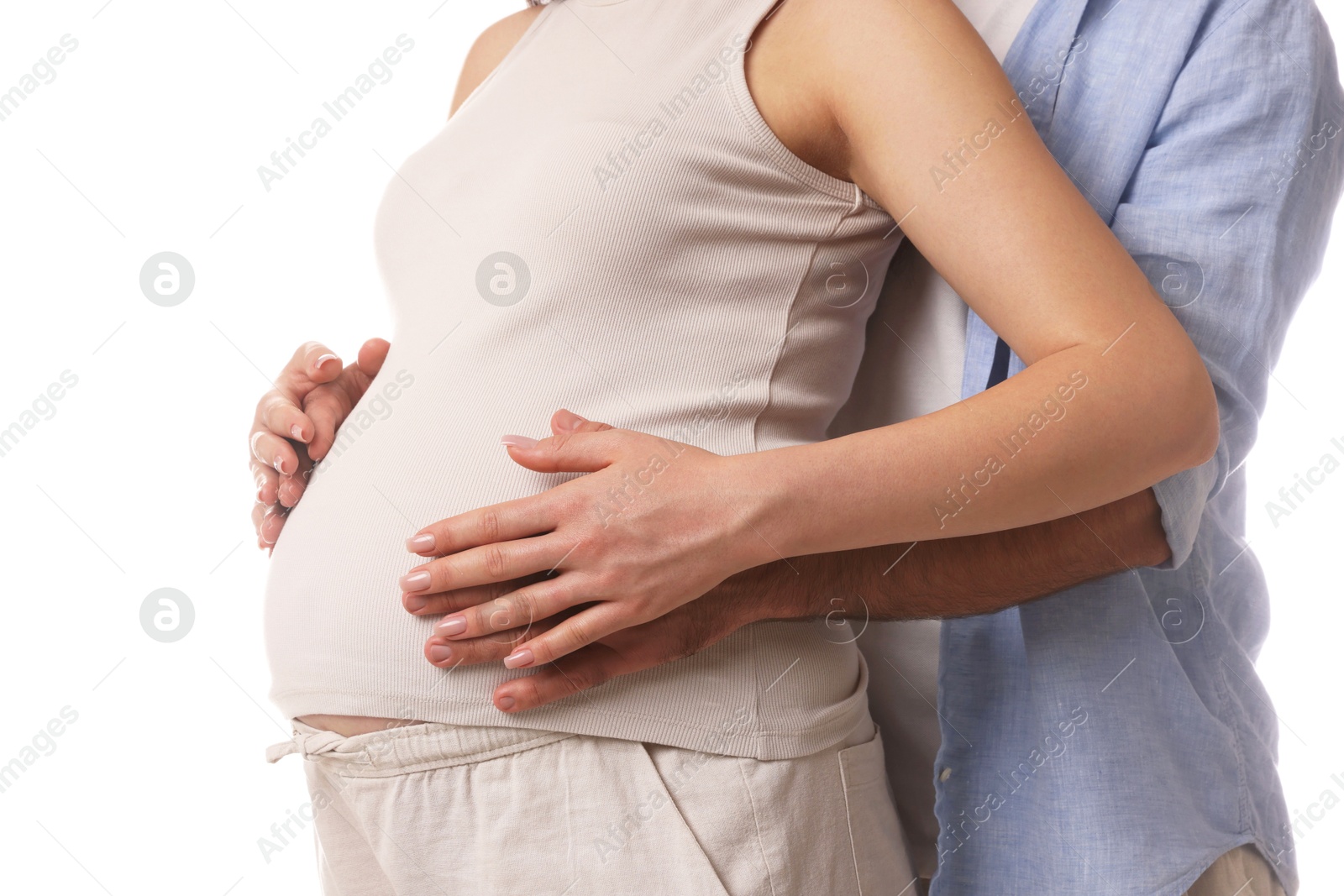 Photo of Man hugging her pregnant wife on white background, closeup