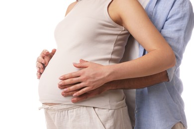 Photo of Man hugging her pregnant wife on white background, closeup