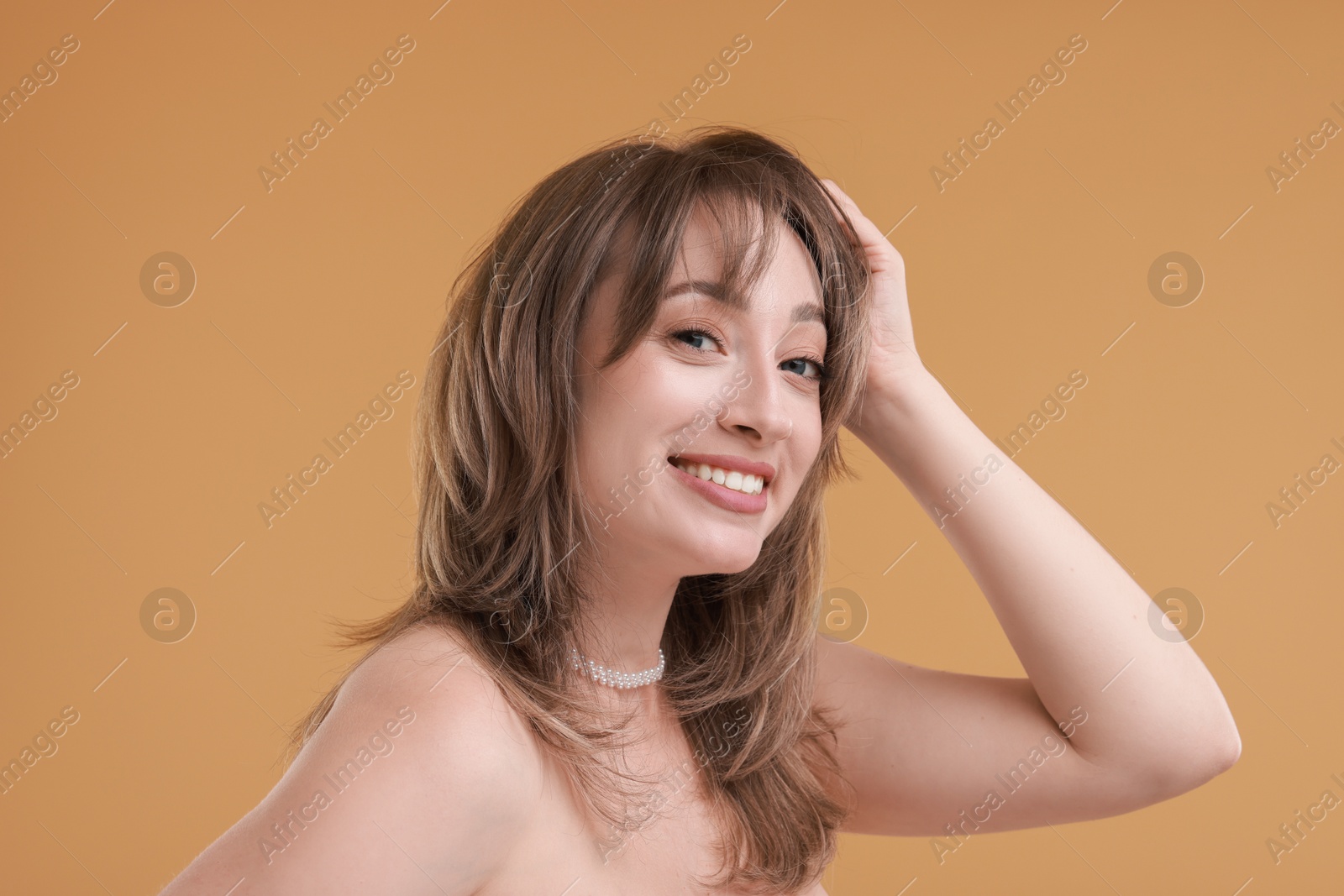 Photo of Attractive woman with stylish haircut on beige background