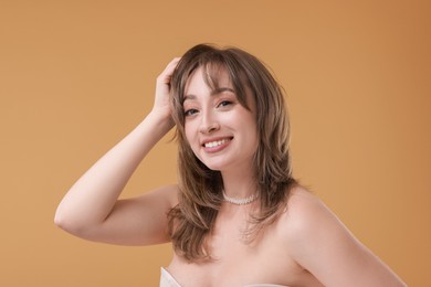 Photo of Attractive woman with stylish haircut on beige background