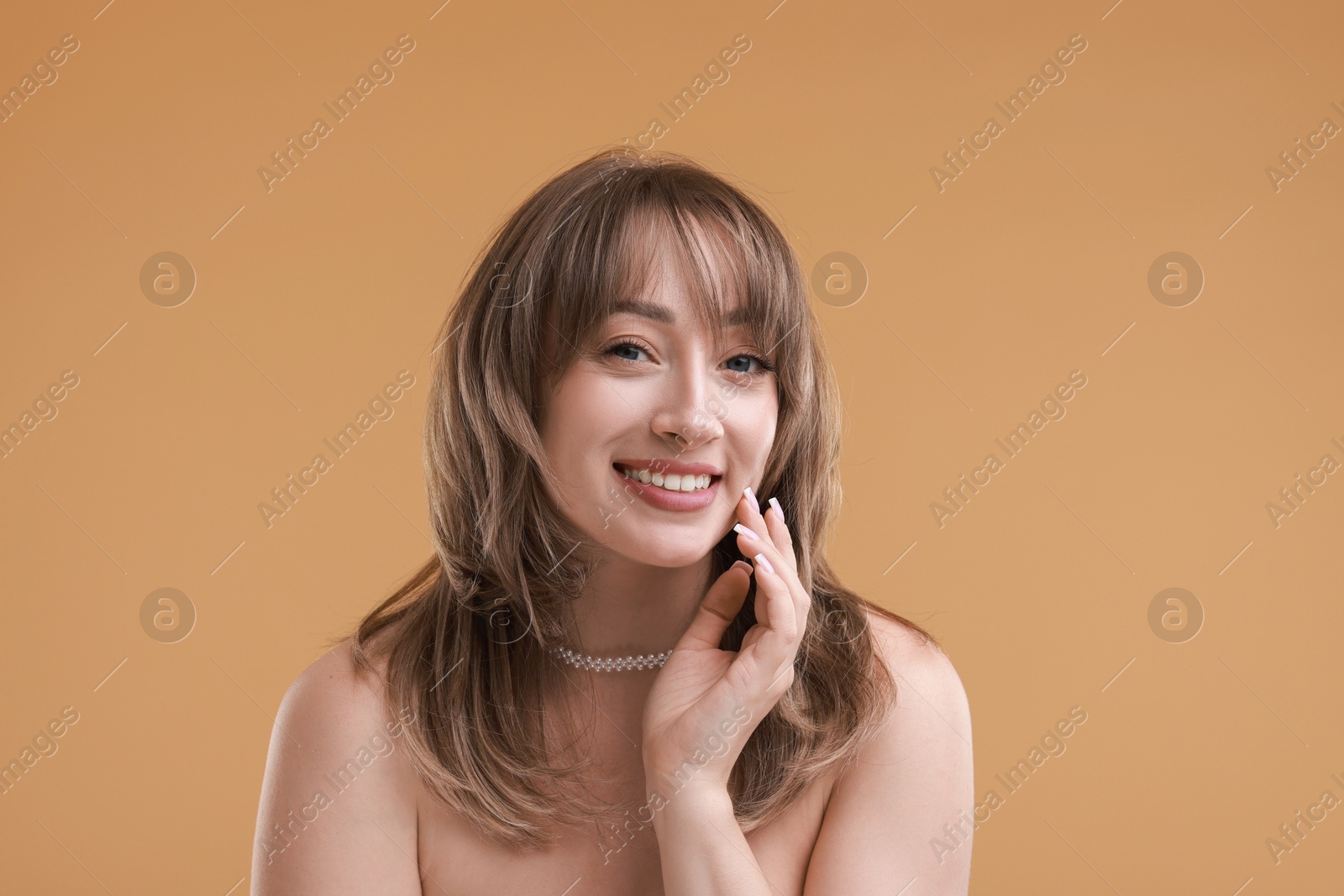 Photo of Attractive woman with stylish haircut on beige background