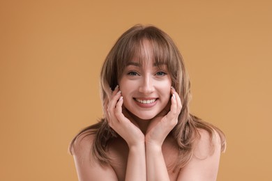 Photo of Attractive woman with stylish haircut on beige background