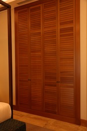 Stylish wooden sliding doors in hotel room