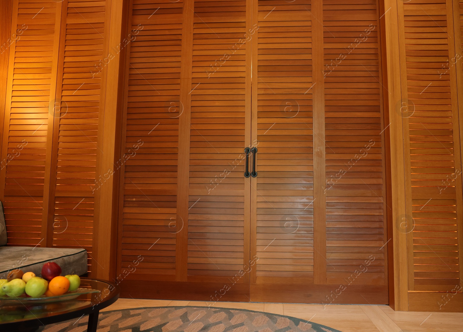 Photo of Stylish wooden sliding doors in hotel room