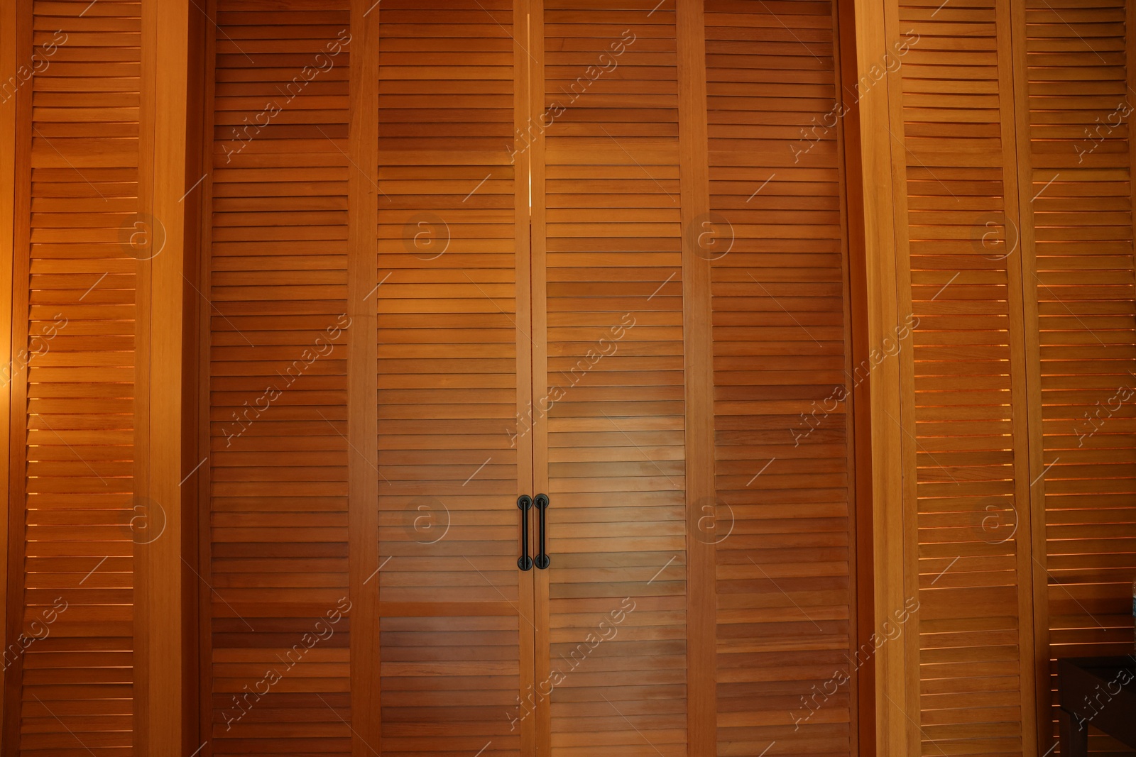 Photo of Stylish wooden sliding doors in hotel room