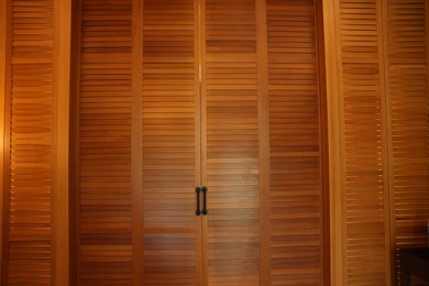 Stylish wooden sliding doors in hotel room