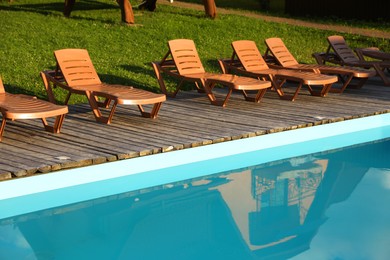 Photo of Outdoor swimming pool and sunbeds in luxury hotel