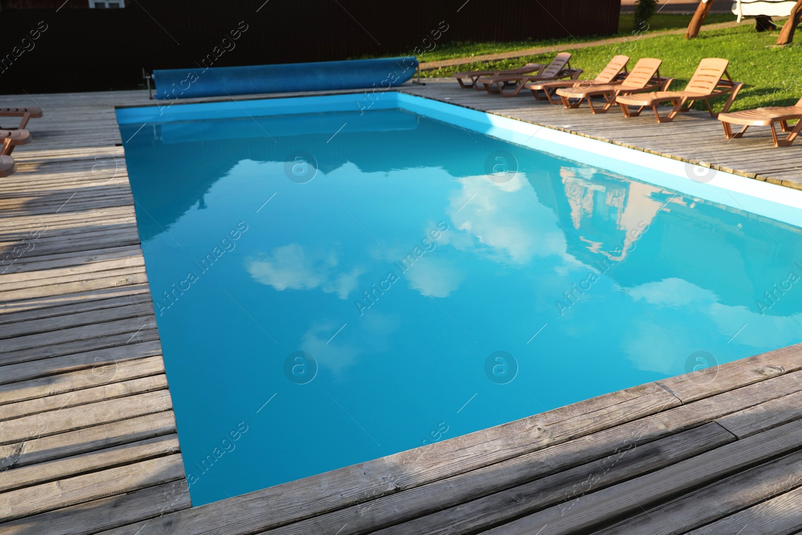 Photo of Outdoor swimming pool and sunbeds in luxury hotel