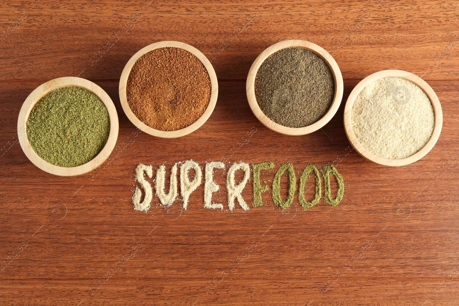 Photo of Word Superfood and different healthy powders on wooden table, flat lay