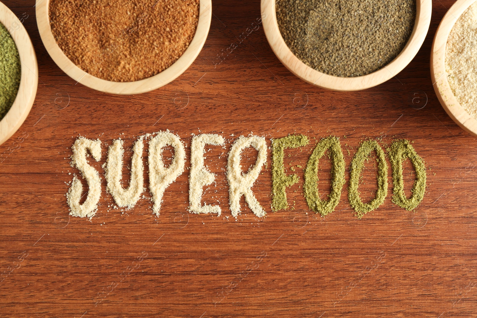 Photo of Word Superfood and different healthy powders on wooden table, flat lay