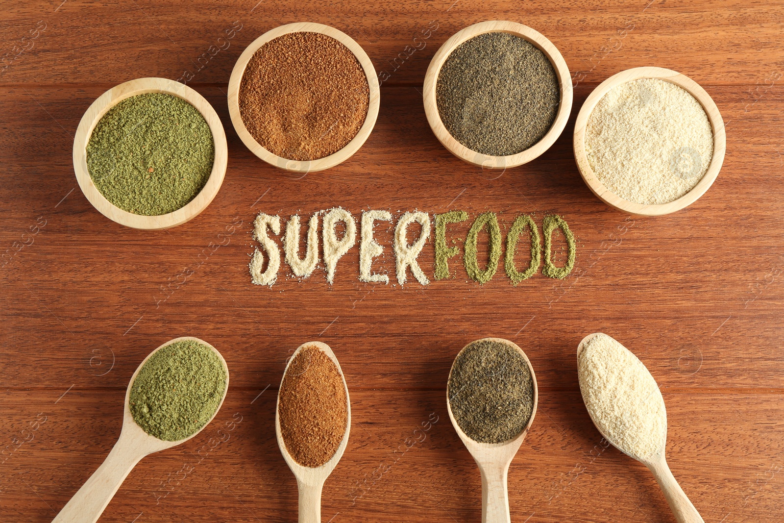 Photo of Word Superfood and different healthy powders on wooden table, flat lay