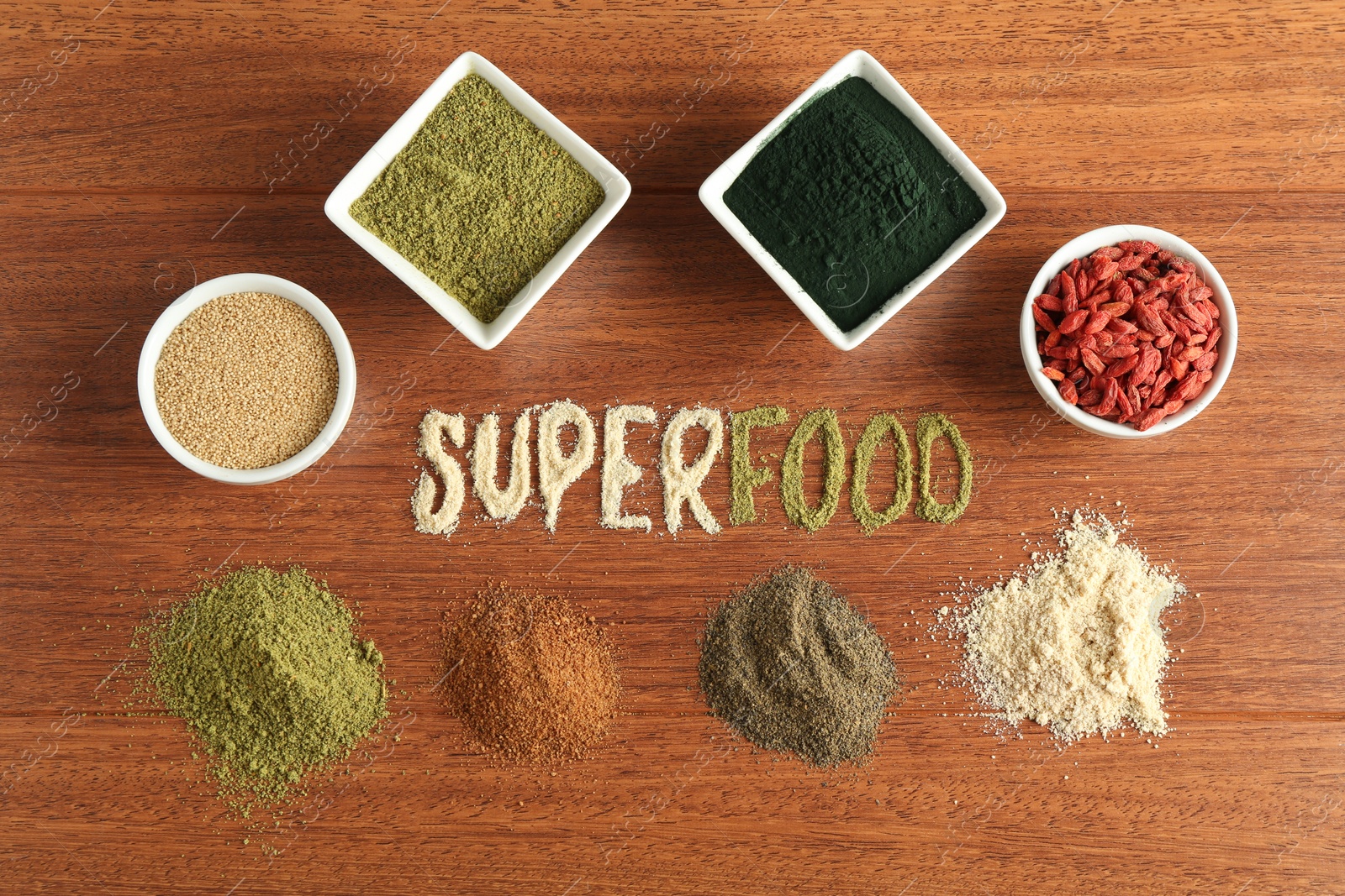 Photo of Word Superfood and different healthy powders on wooden table, flat lay