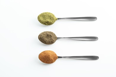 Photo of Different superfood powders in spoons on white background, above view