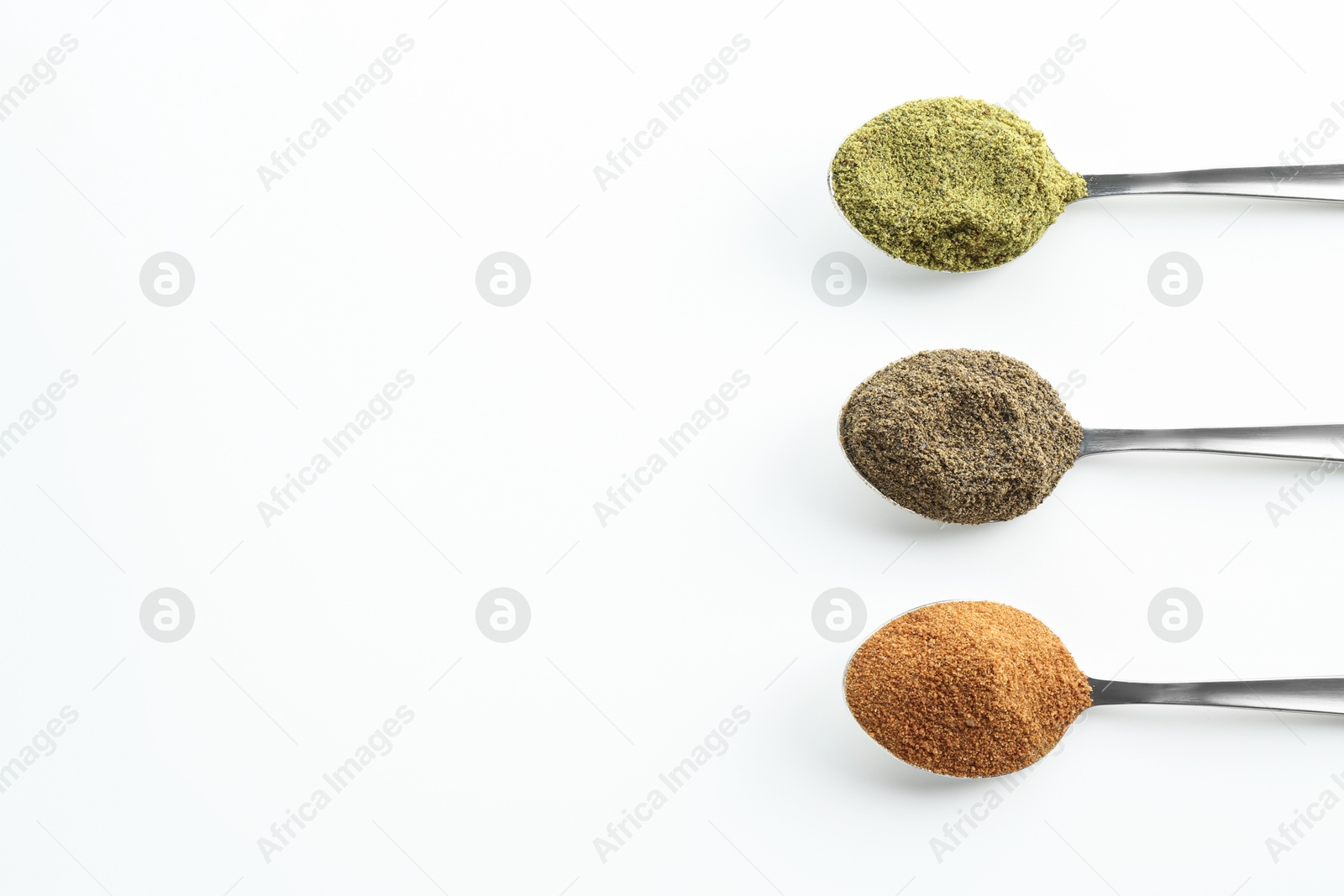 Photo of Different superfood powders in spoons on white background, above view. Space for text