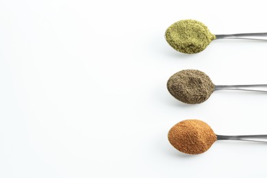 Photo of Different superfood powders in spoons on white background, above view. Space for text