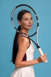 Beautiful young woman with tennis racket on light blue background