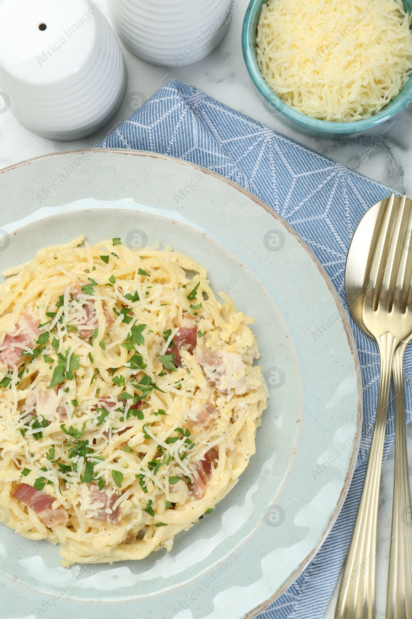 Photo of Delicious pasta Carbonara with bacon served on table, flat lay