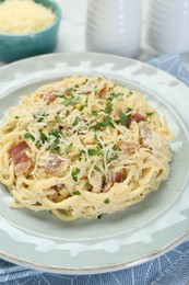 Photo of Delicious pasta Carbonara with bacon on table, closeup