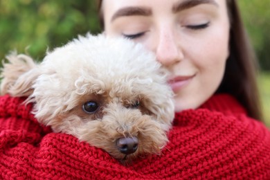 Portrait of woman with cute dog outdoors, closeup