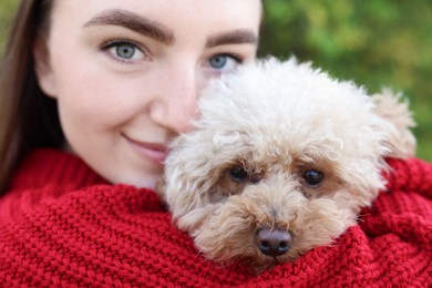 Photo of Portrait of woman with cute dog outdoors, closeup