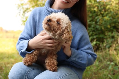 Photo of Smiling woman with cute dog outdoors, closeup