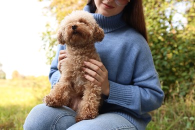 Photo of Woman with cute dog outdoors, closeup view