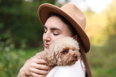 Photo of Portrait of woman with cute dog outdoors