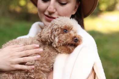 Photo of Woman with her cute dog outdoors, closeup