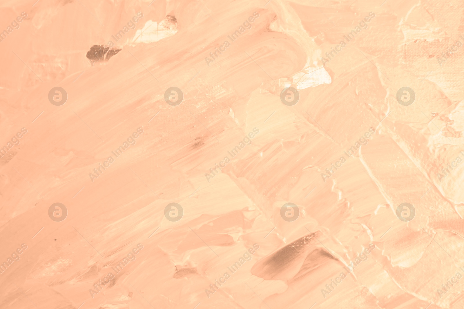 Image of Peach fuzz color paint strokes as background, closeup