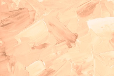 Image of Peach fuzz color paint strokes as background, closeup