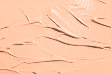 Image of Skin foundation as background, closeup. Peach fuzz color