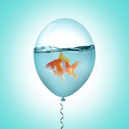 Image of Balloon with water and goldfish against light blue background