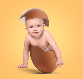 Image of Cute little baby in eggshell on orange background