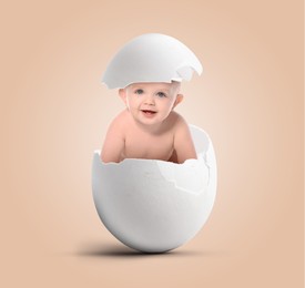 Cute little baby in eggshell on pink beige background