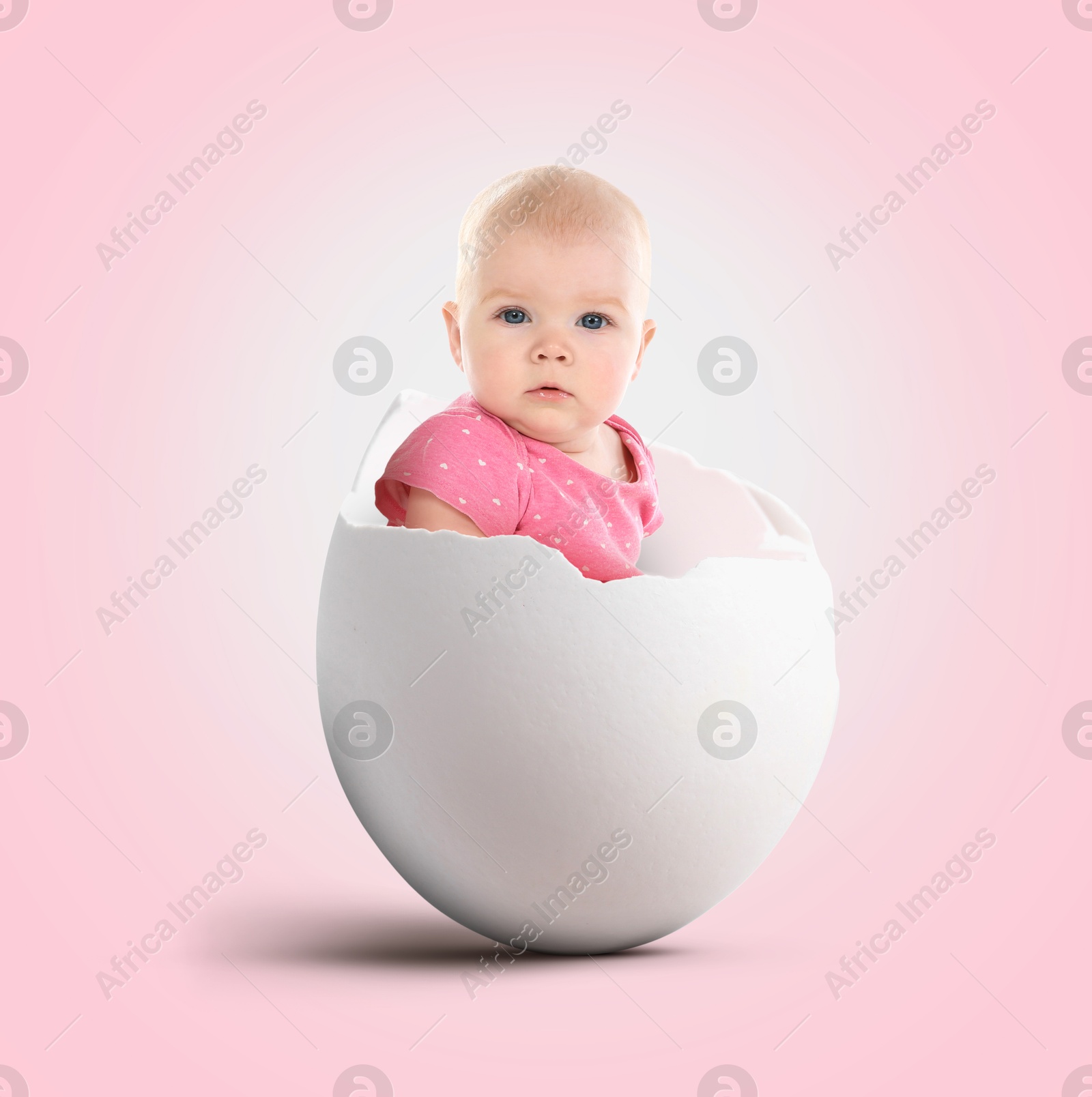 Image of Cute little baby in eggshell on pink background