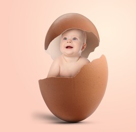 Image of Cute little baby in eggshell on beige pink background