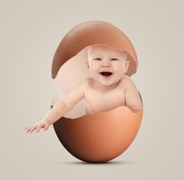 Image of Cute little baby in eggshell on greyish beige background