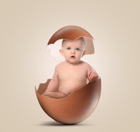 Cute little baby in eggshell on greyish beige background