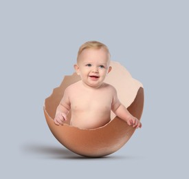 Image of Cute little baby in eggshell on grey background