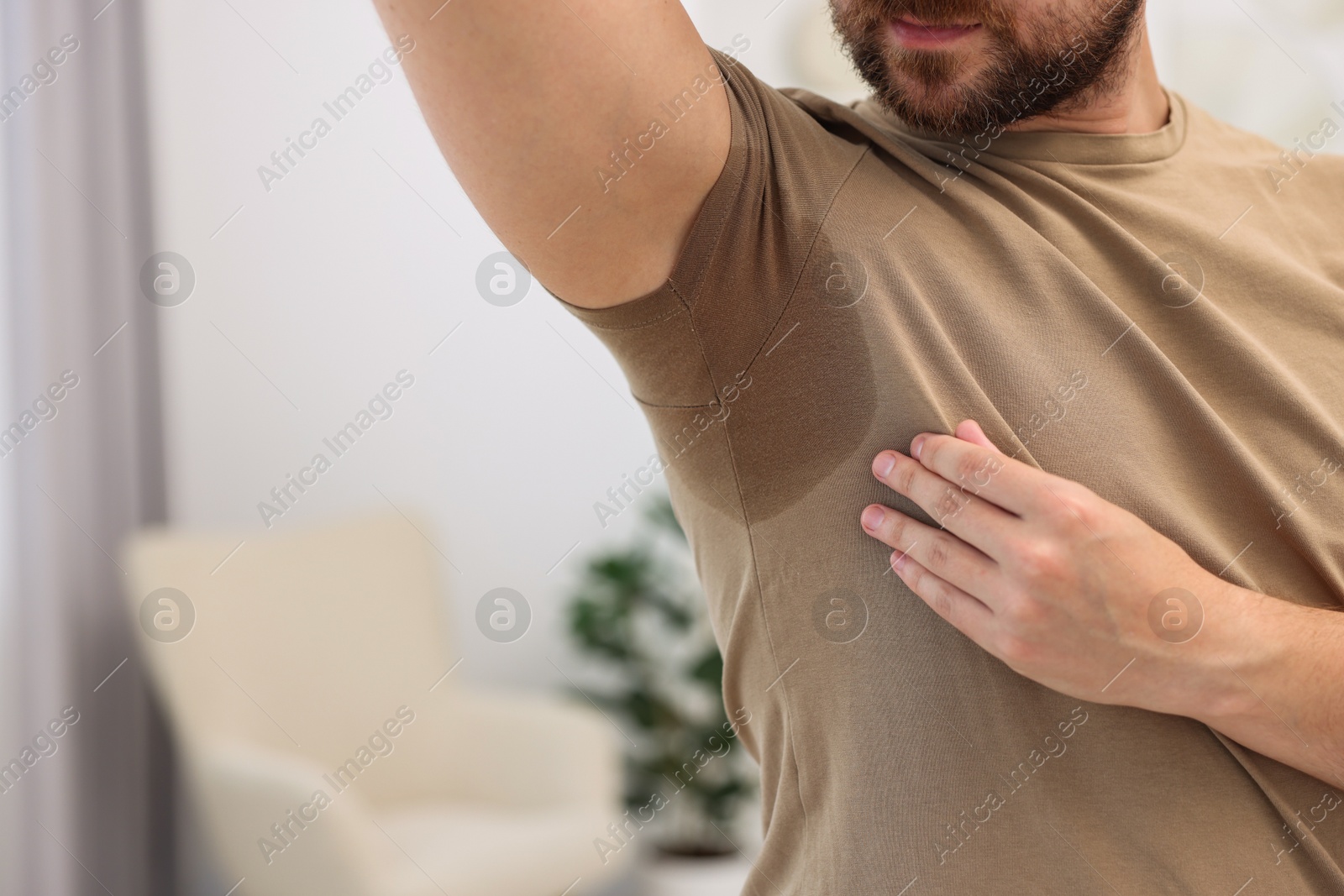 Photo of Man before using deodorant at home, closeup. Space for text