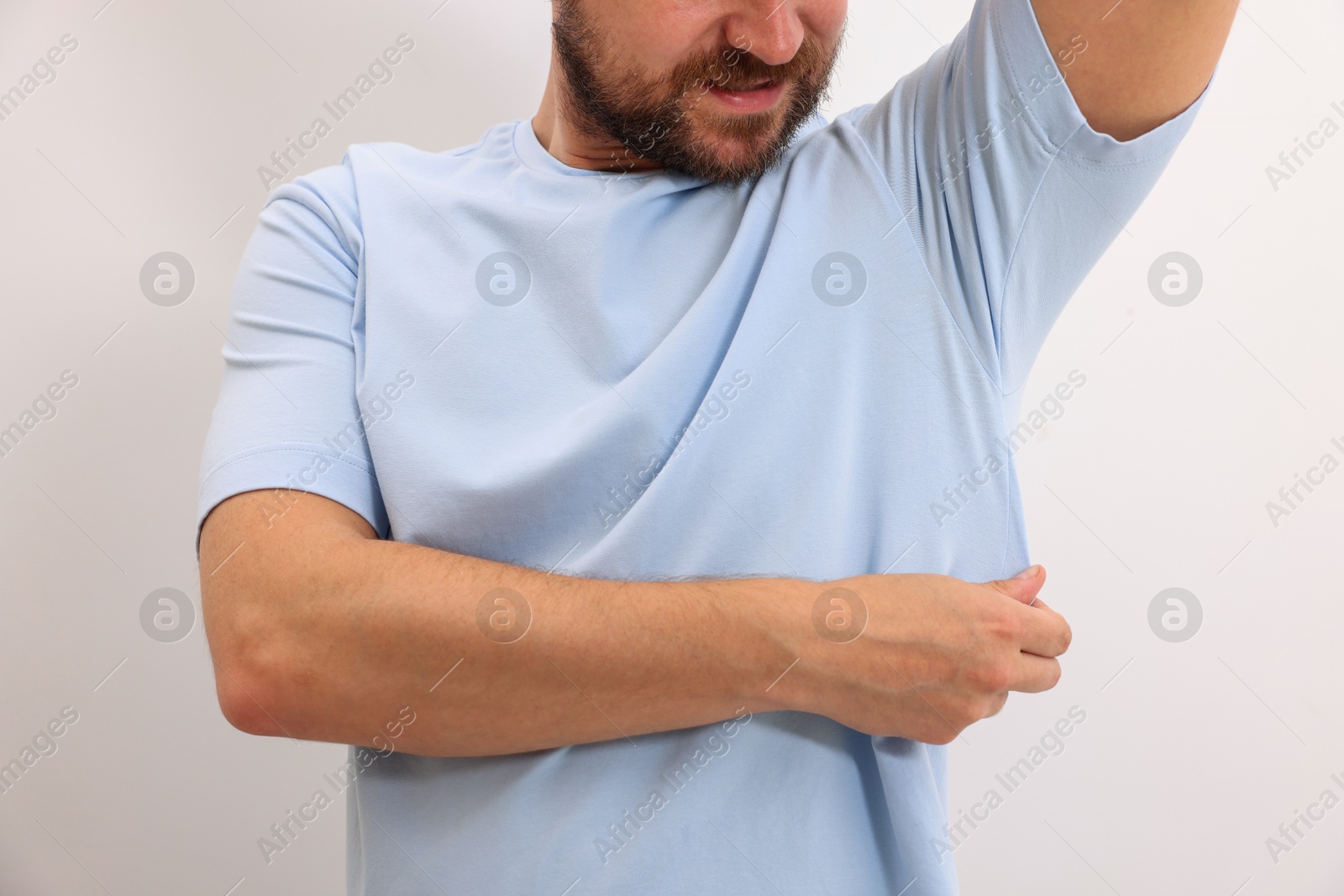 Photo of Man after using deodorant on white background, closeup