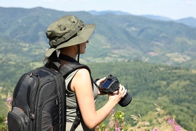 Photo of Photographer with backpack and camera in beautiful mountains. Space for text