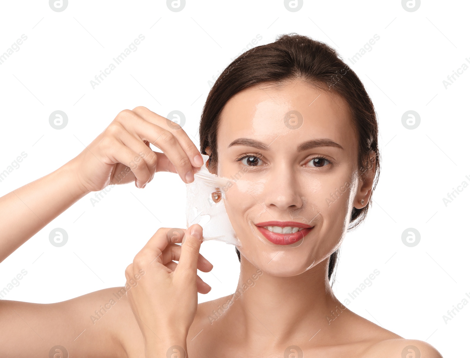 Photo of Smiling woman peeling off face mask on white background